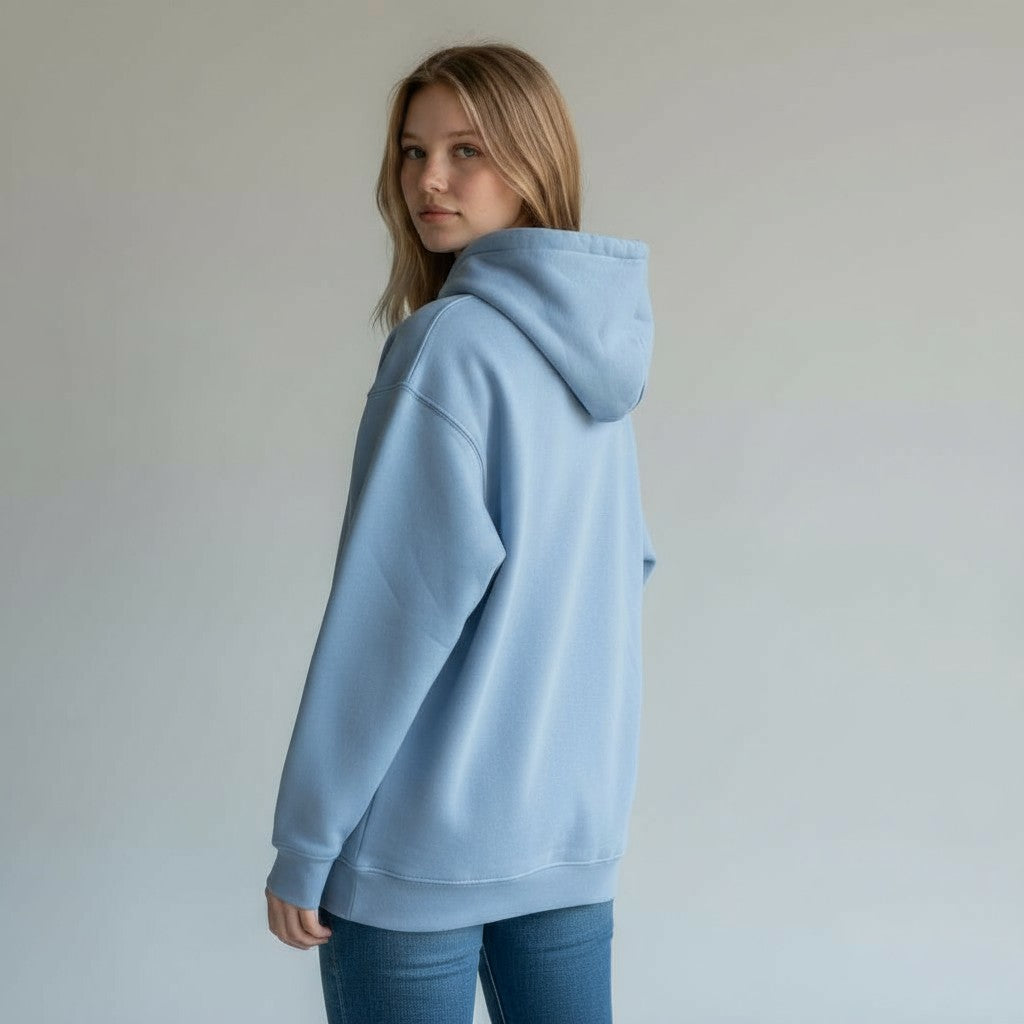 Person wearing a light blue hoodie against a plain background