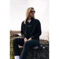 Obsidian Black Fearless Fleece by Legacy29, a premium mental health support apparel featuring an embroidered logo, worn outdoors for a stylish and cozy look.