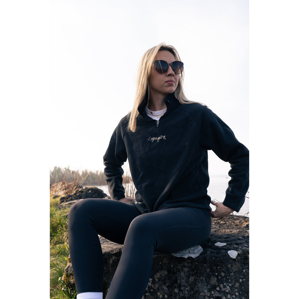 Legacy29 Obsidian Black Fearless Fleece, designed for emotional resilience, showcased in an outdoor setting with a relaxed and confident posture.
