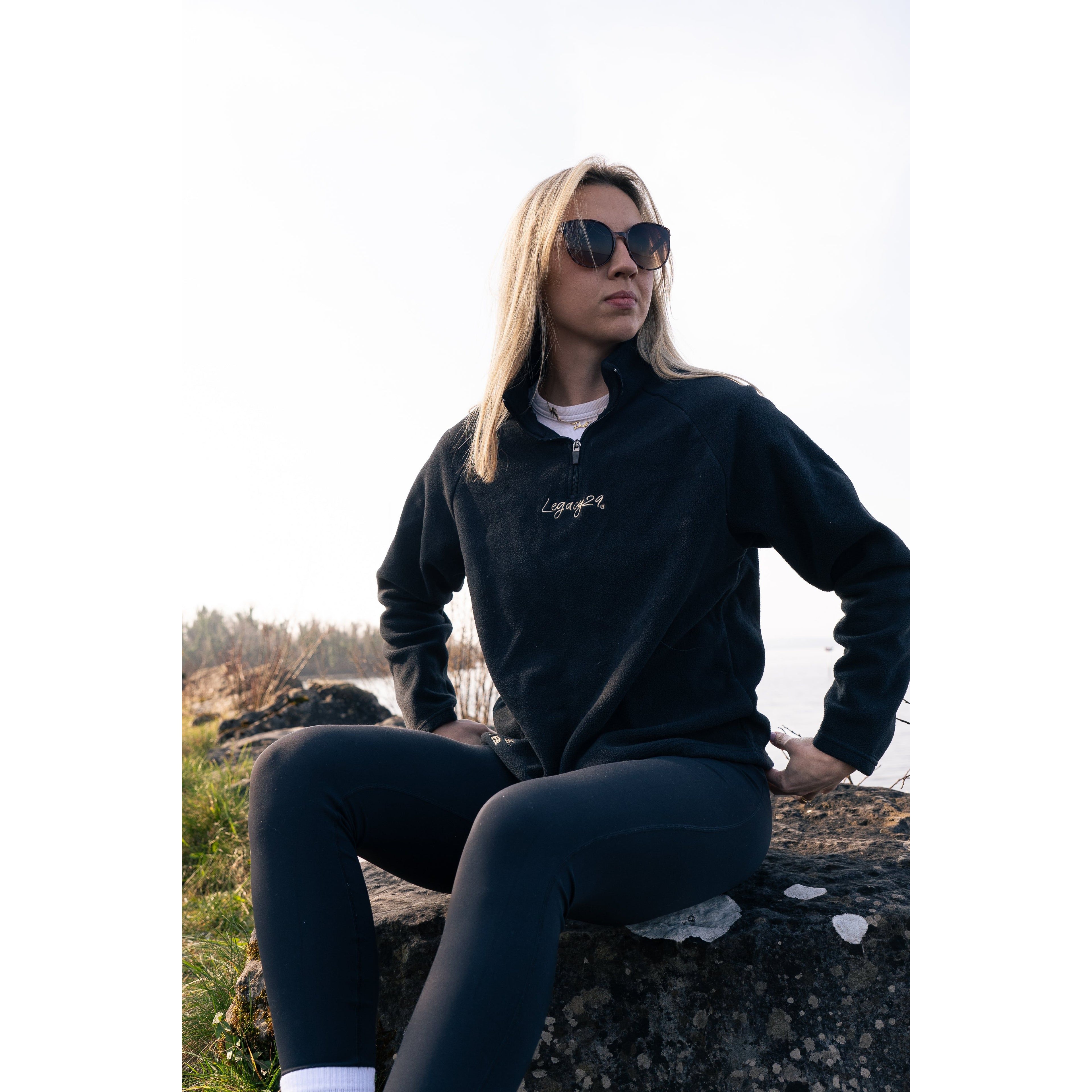 Legacy29 Obsidian Black Fearless Fleece, designed for emotional resilience, showcased in an outdoor setting with a relaxed and confident posture.
