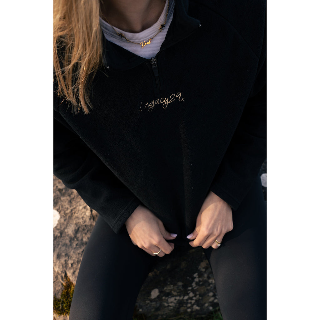 Close-up of the Legacy29 Obsidian Black Fearless Fleece, highlighting the embroidered logo and soft fleece texture for comfort and style.