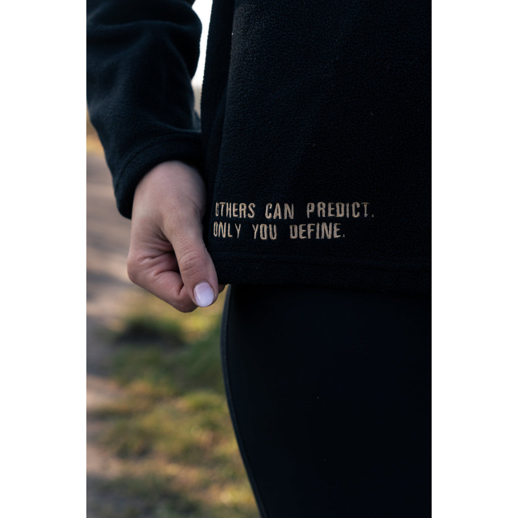 Detailed view of the motivational quote on the Legacy29 Obsidian Black Fearless Fleece, promoting self-empowerment and mental health awareness.