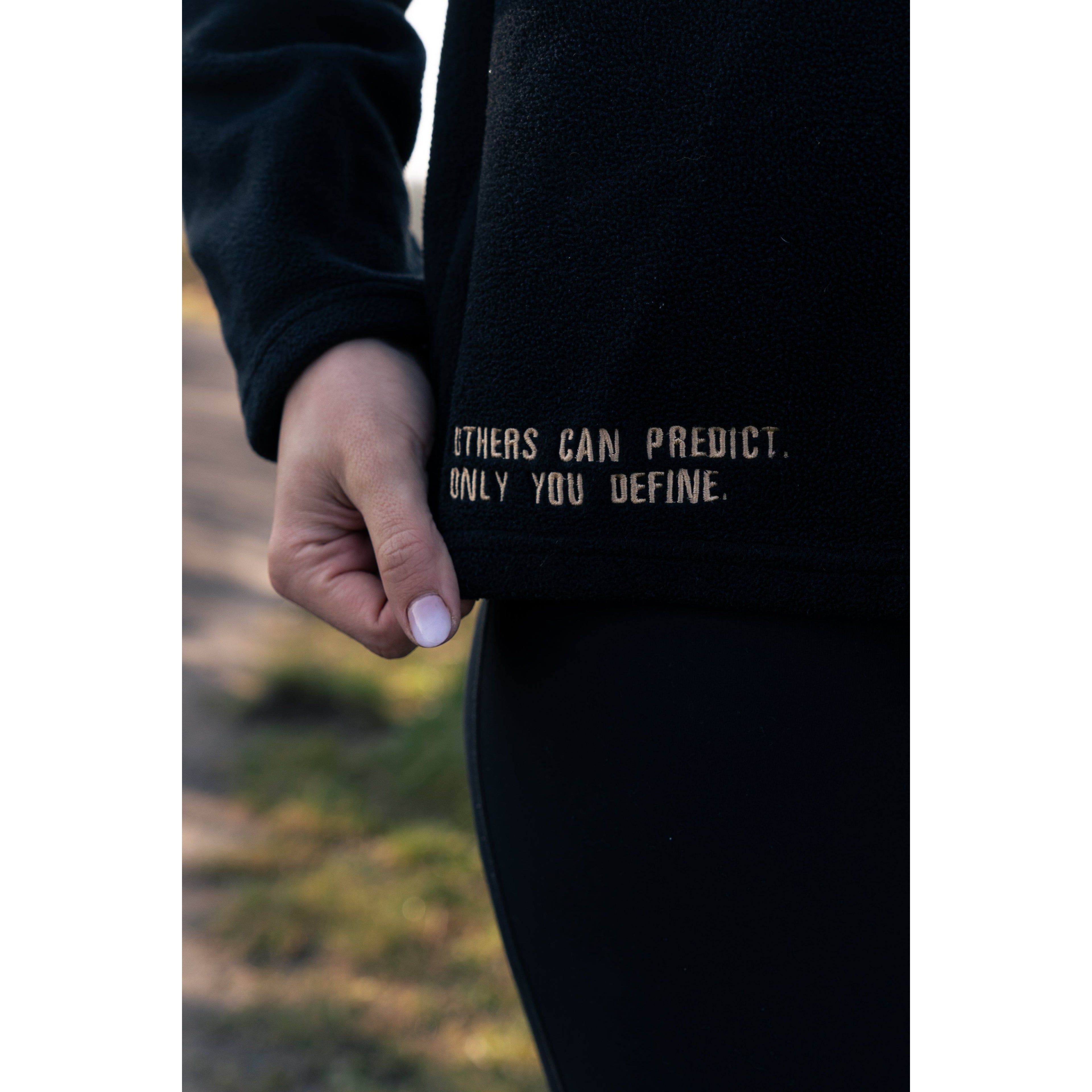 Detailed view of the motivational quote on the Legacy29 Obsidian Black Fearless Fleece, promoting self-empowerment and mental health awareness.