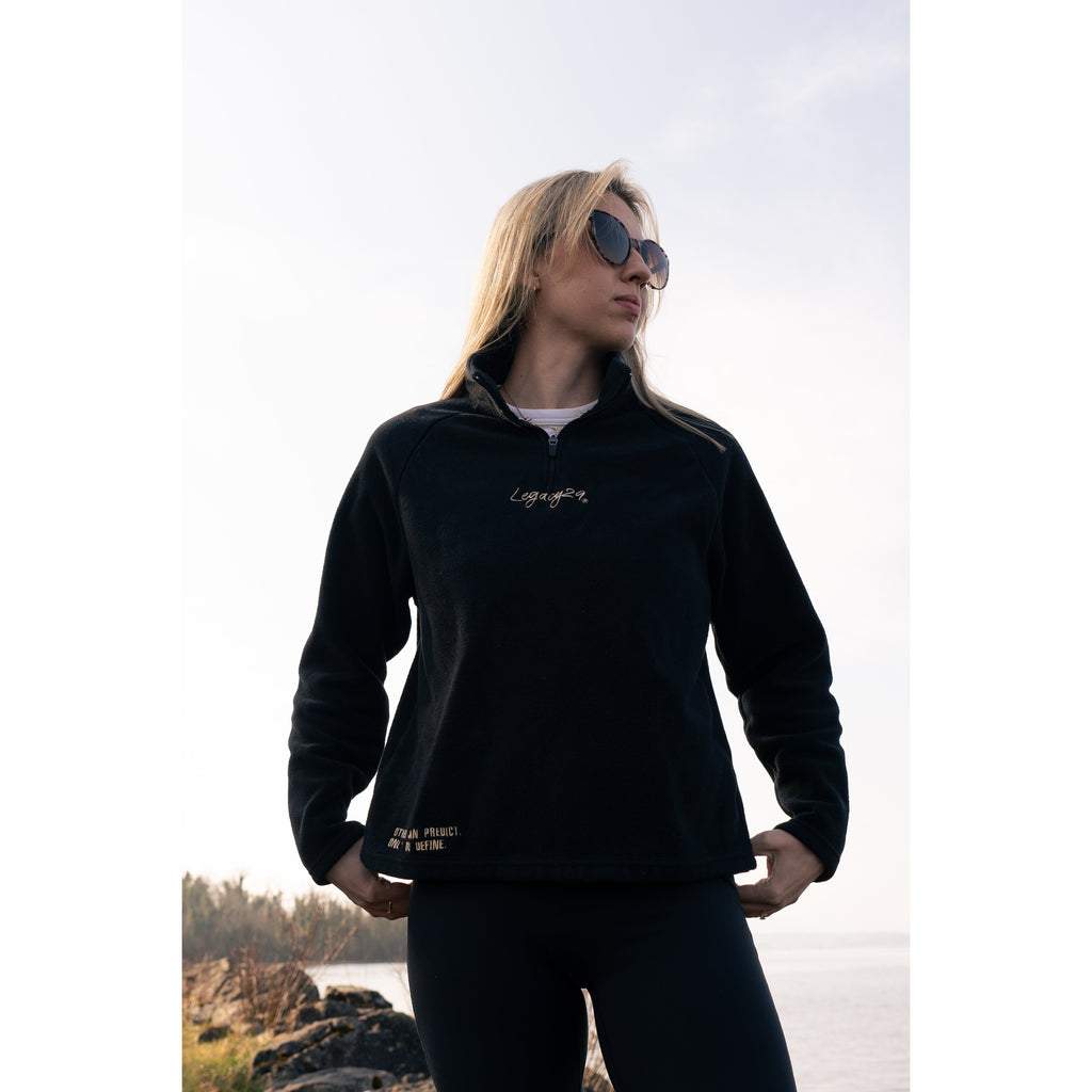 Model confidently posing in the Legacy29 Obsidian Black Fearless Fleece, highlighting its stylish design and empowering message for mental health support.