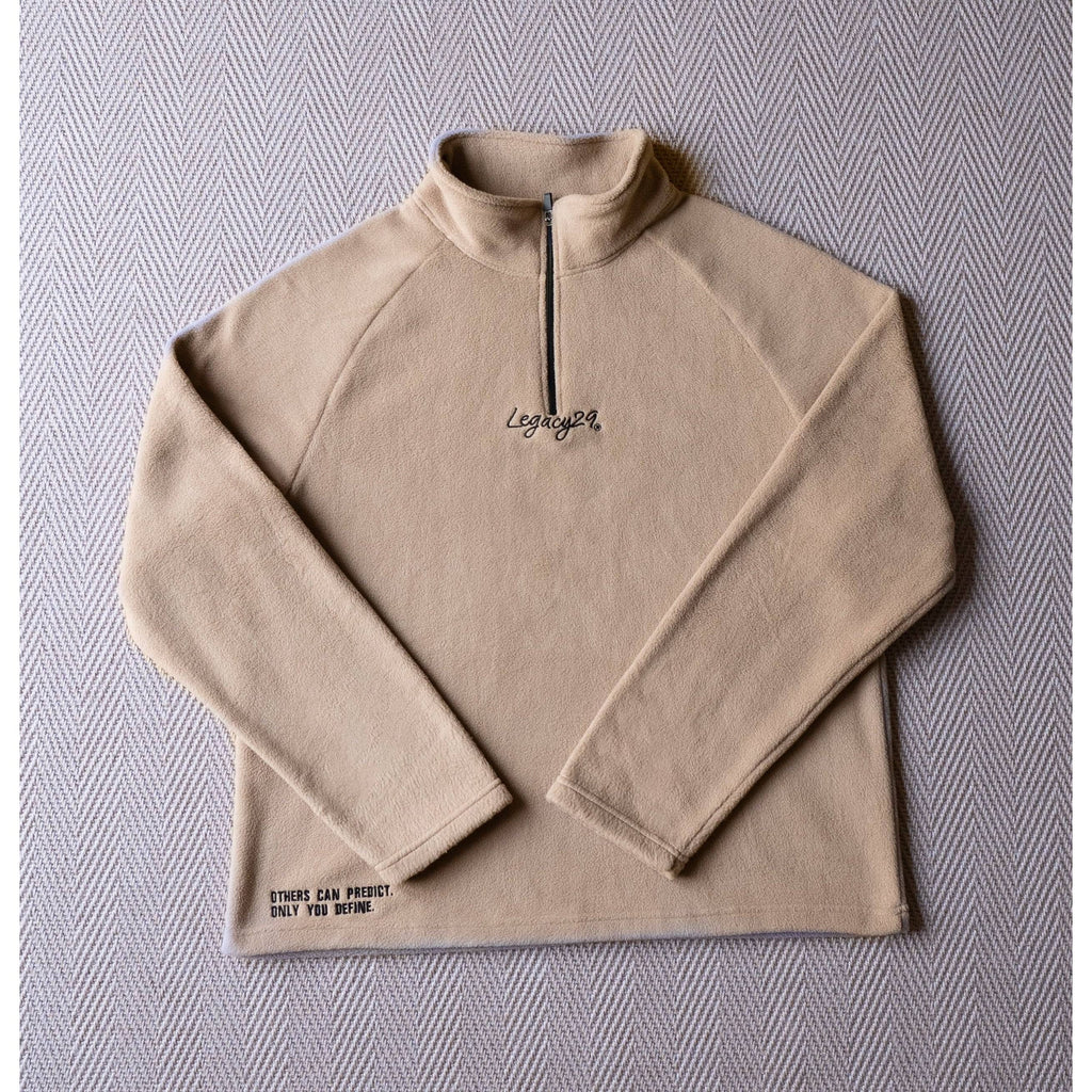 Ecru Sandstone Fearless Fleece by Legacy29 laid flat, showcasing its premium soft fabric, half-zip design, and embroidered mental health support message.