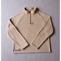 Ecru Sandstone Fearless Fleece by Legacy29 laid flat, showcasing its premium soft fabric, half-zip design, and embroidered mental health support message.