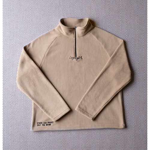 Ecru Sandstone Fearless Fleece by Legacy29 laid flat, showcasing its premium soft fabric, half-zip design, and embroidered mental health support message.
