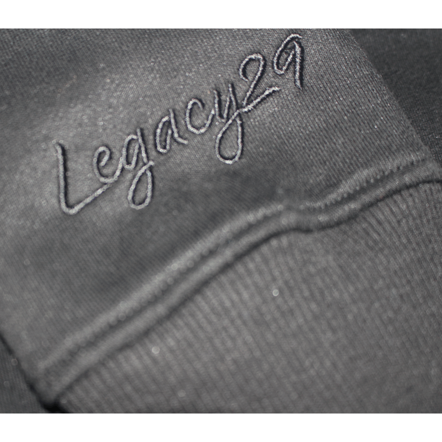 Legacy29 embroidered logo on sleeve of black jumper