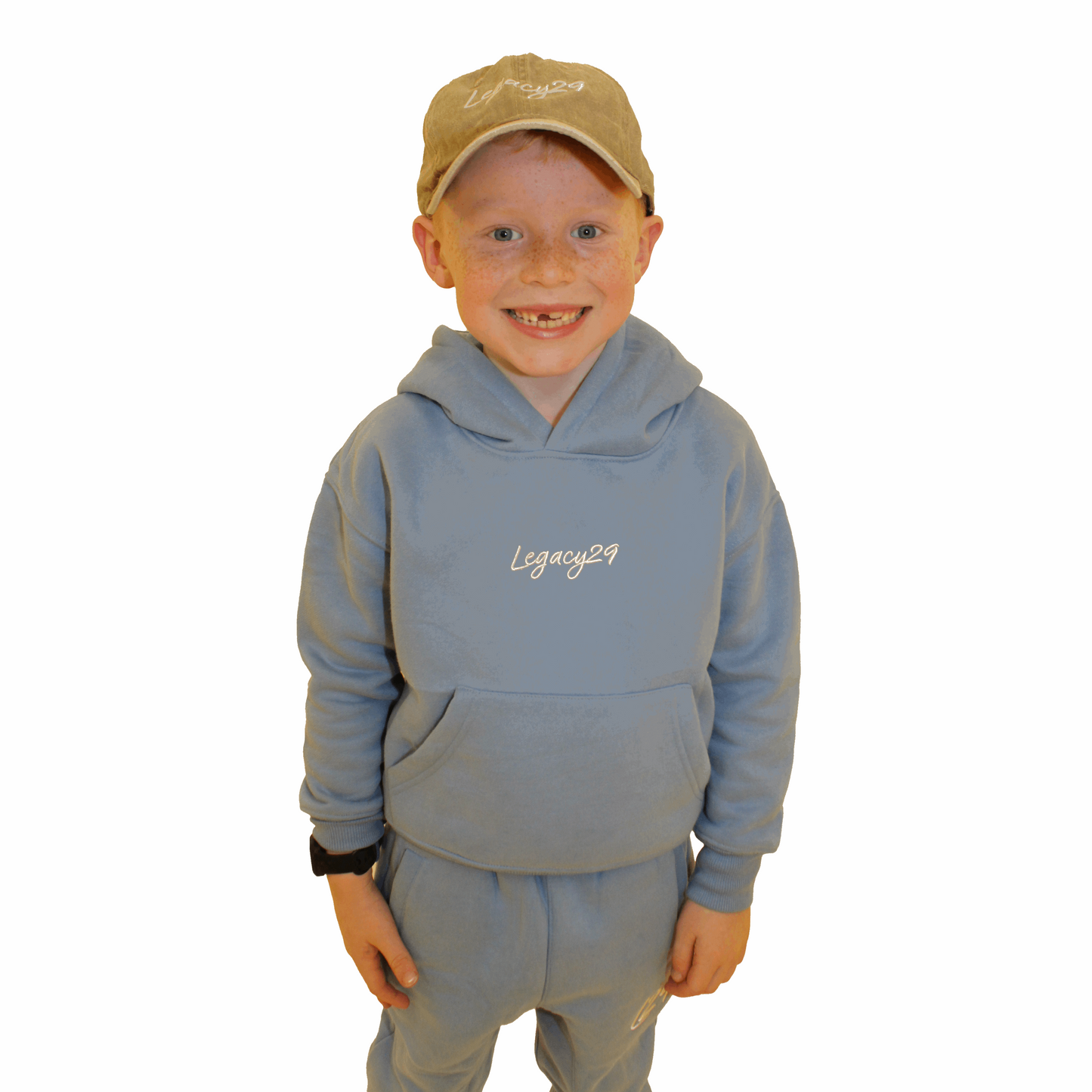 Junior model wears beige hat and blue junior set