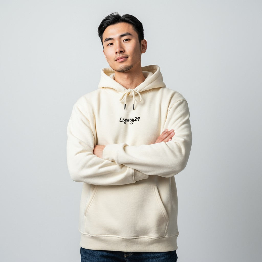 Man wearing a beige hoodie with 'Legacy29' logo on a light gray background