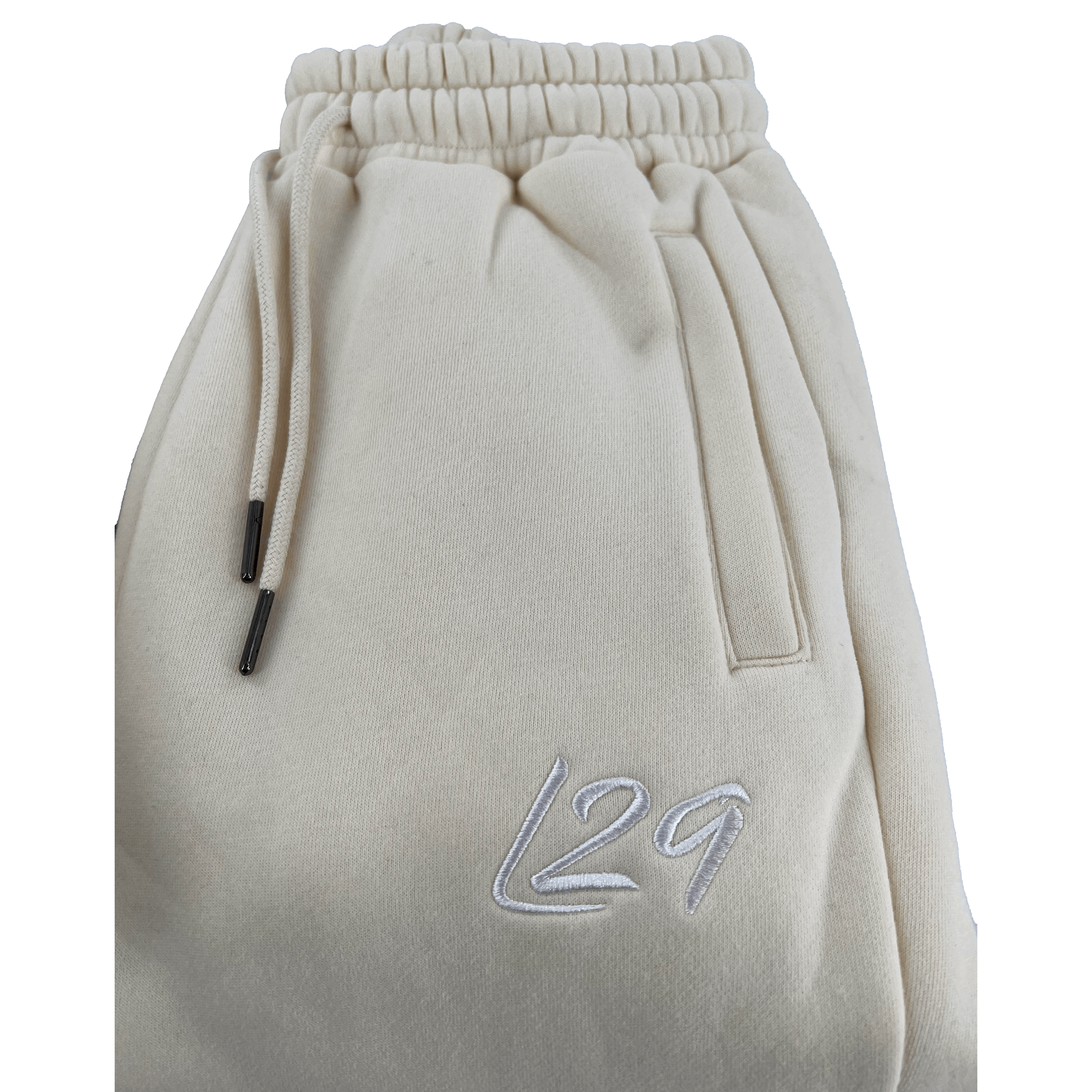 Legacy29 Junior Cream Tracksuit Bottoms with embroidered L29 logo and adjustable drawstring waist. Soft and comfortable for everyday wear.