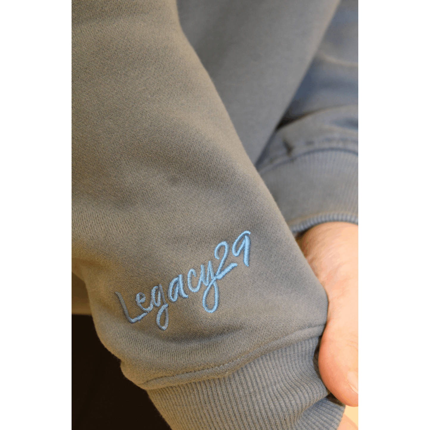 Legacy29 embroidered logo on sleeve of matte blue jumper