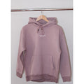 Legacy29 Lavender and Let Go comfort hoodie hanging on a wooden hanger. Soft lavender shade with embroidered logo, designed for resilience and relaxation.