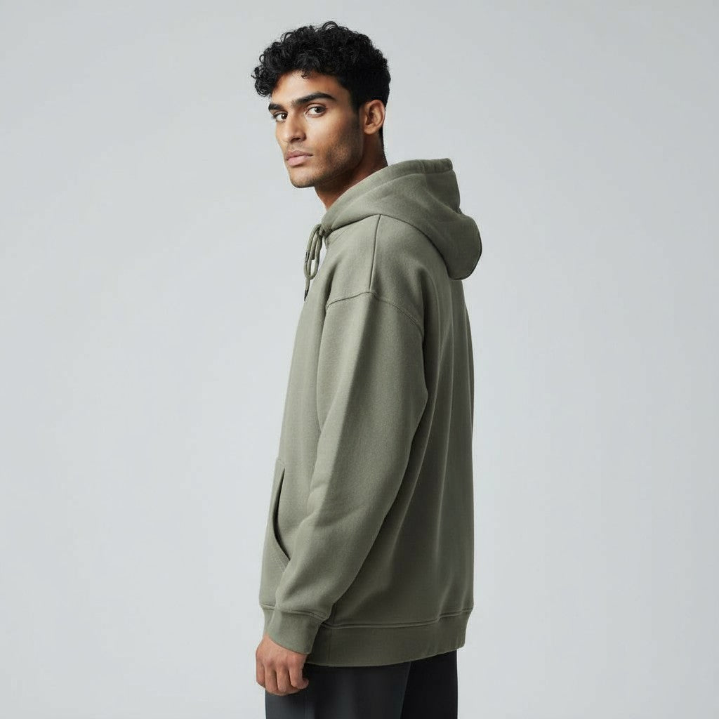 Man wearing a green hoodie against a plain background