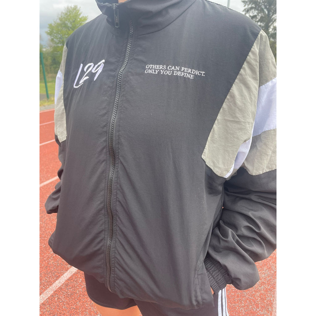 Gray jacket with text on a track field