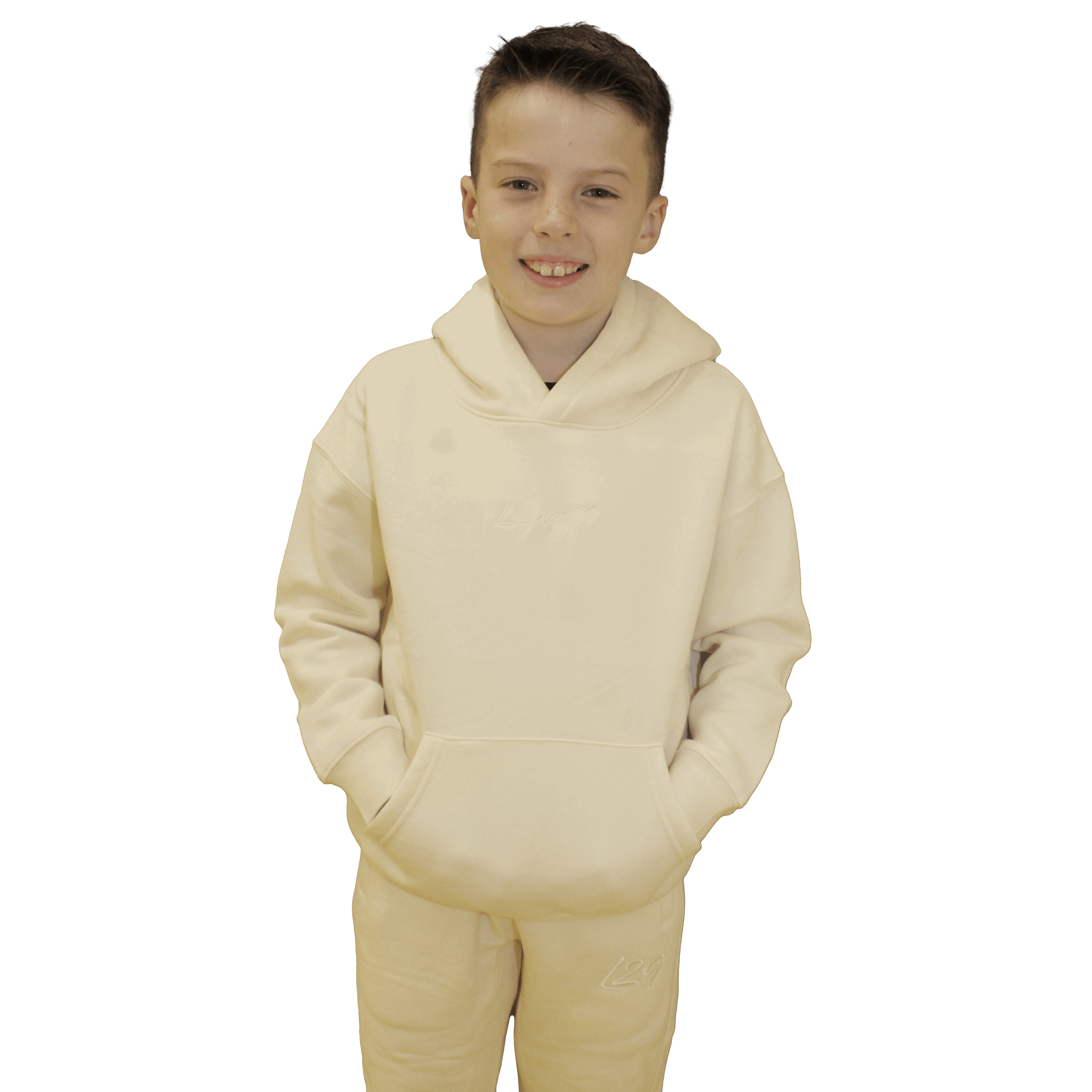 Child wearing Legacy29 Junior Cream Comfort Set, including hoodie and tracksuit bottoms. A cosy and stylish outfit for kids.