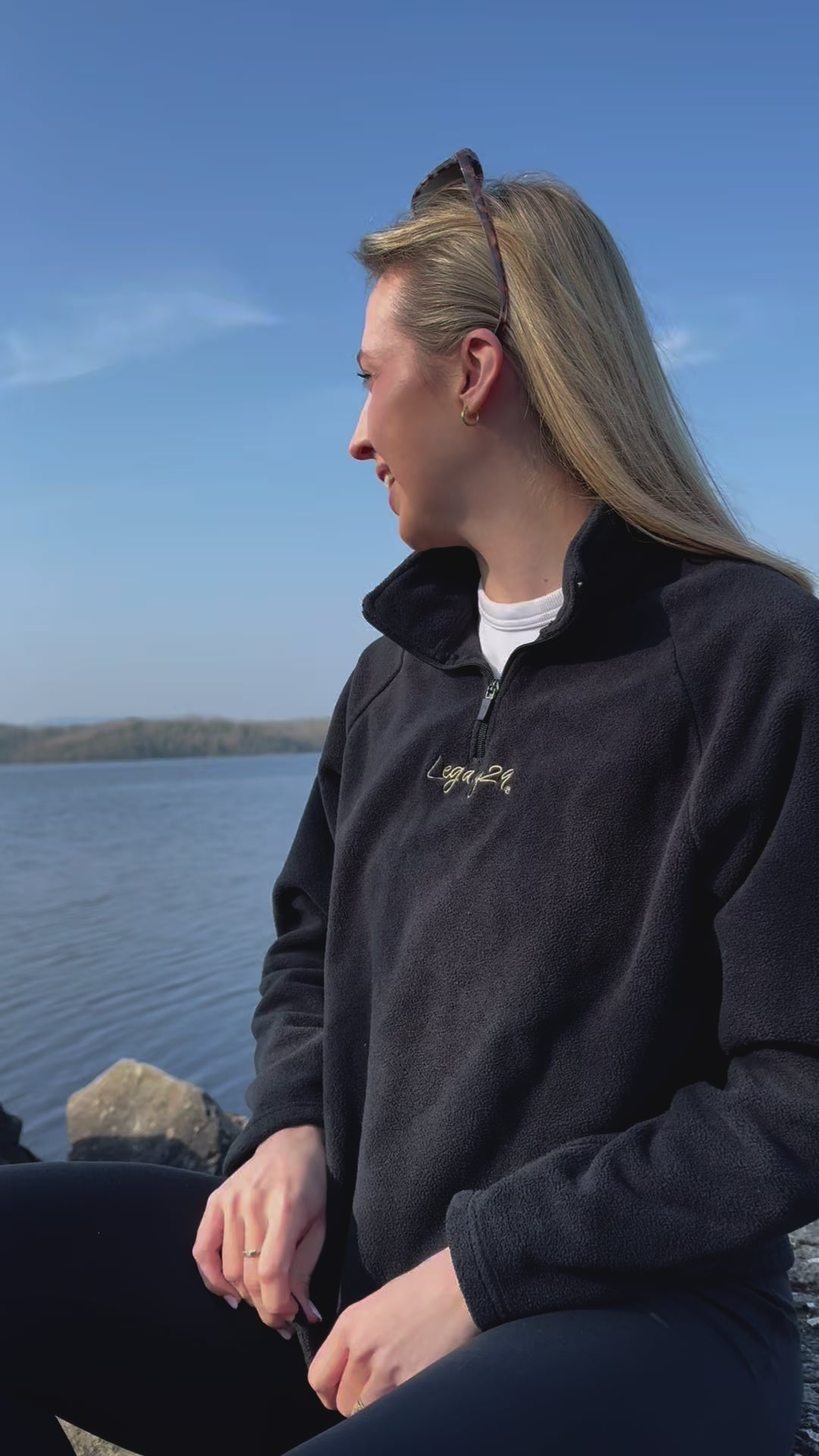 Legacy29 Obsidian Black Fearless Fleece worn by a model near a serene lake, embodying tranquility, comfort, and mental health awareness.